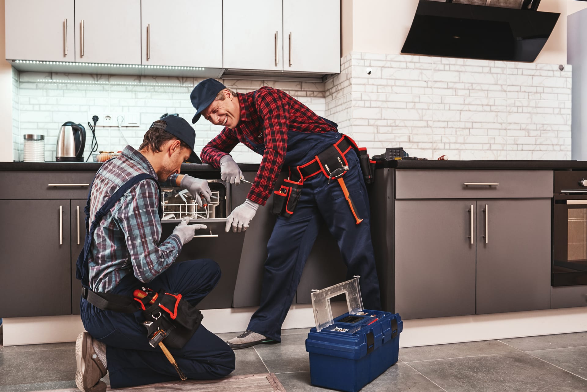 Handyman installing kitchen faucet
